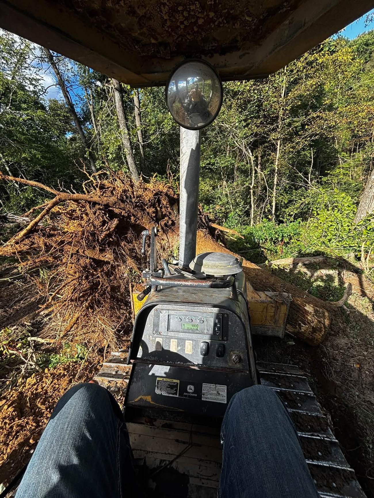 Operator's view during a land clearing project removing tree debris